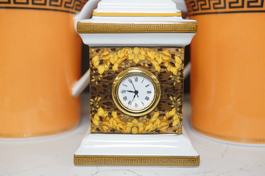 Five boxed Rosenthal for Versace mugs in various colours with Greek key pattern decoration together with a boxed miniature timepiece, 8.5cm high (6). Condition - good.